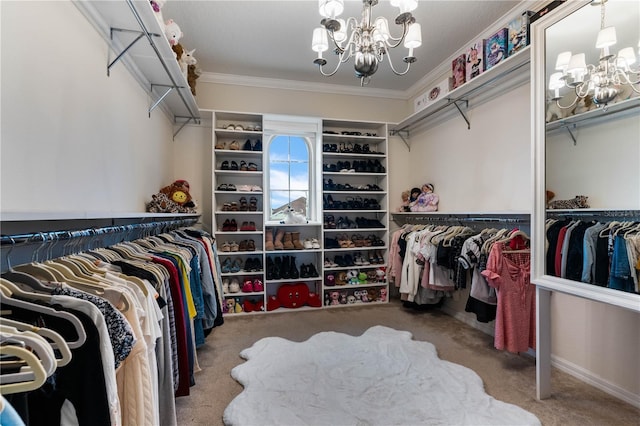 walk in closet featuring an inviting chandelier and carpet flooring