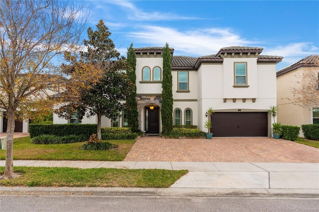 mediterranean / spanish house with a garage