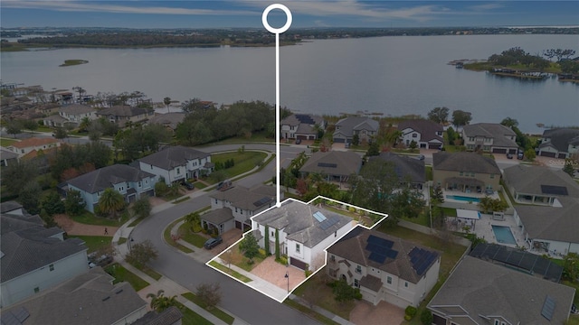 birds eye view of property with a water view