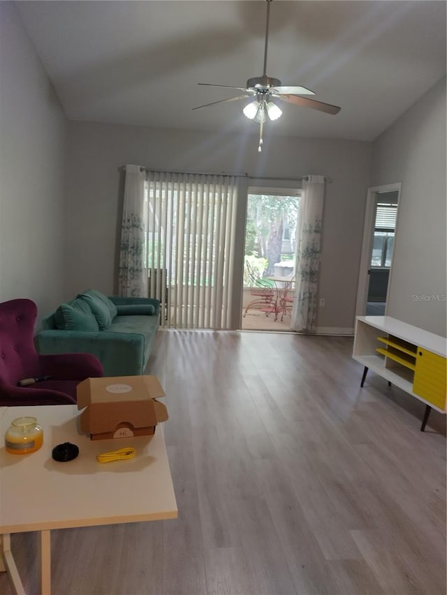 living room with vaulted ceiling, ceiling fan, and hardwood / wood-style floors