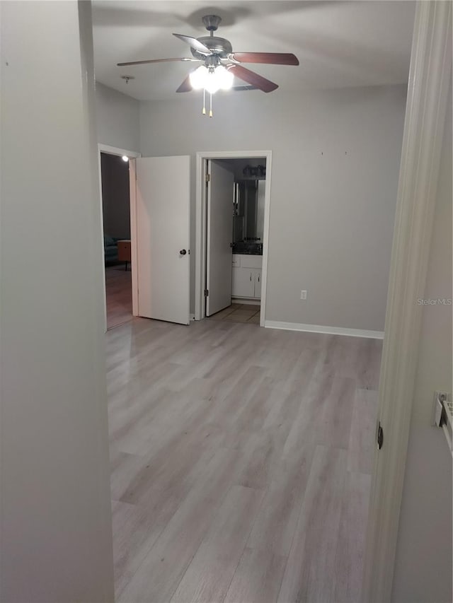 unfurnished room with ceiling fan and light wood-type flooring