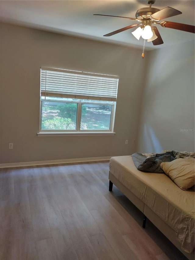 unfurnished bedroom featuring ceiling fan and light wood-type flooring