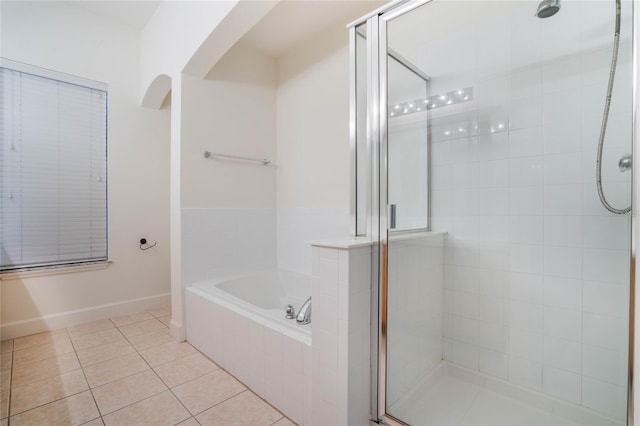 bathroom with independent shower and bath and tile patterned floors