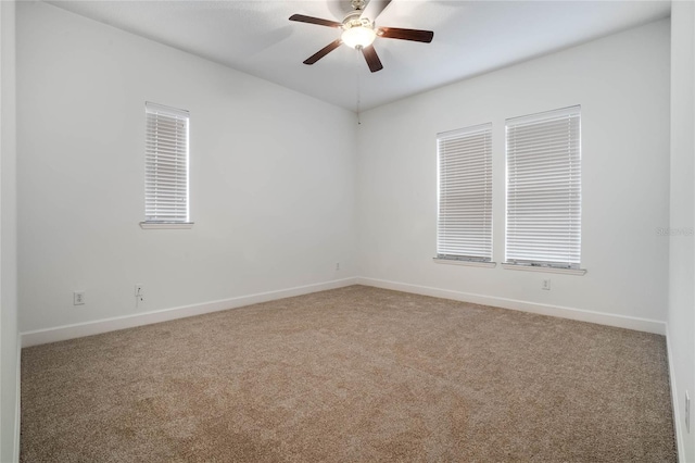 empty room featuring ceiling fan and carpet flooring