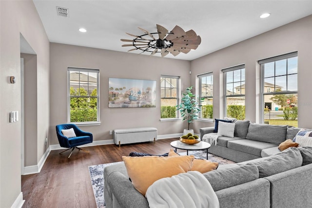 living room featuring ceiling fan and dark hardwood / wood-style floors