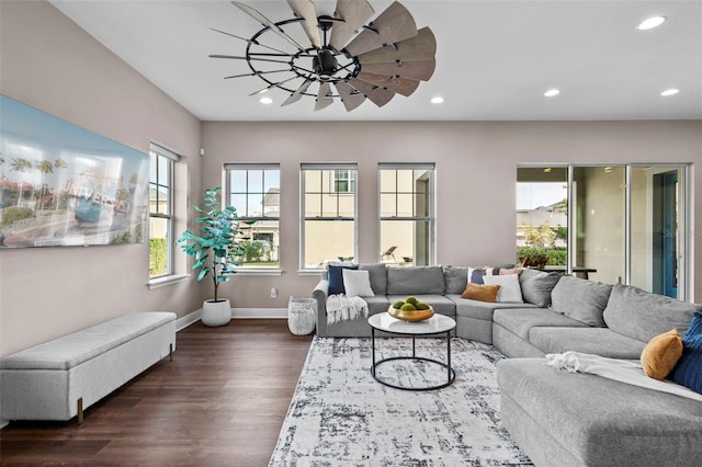 living room featuring ceiling fan and dark wood-type flooring