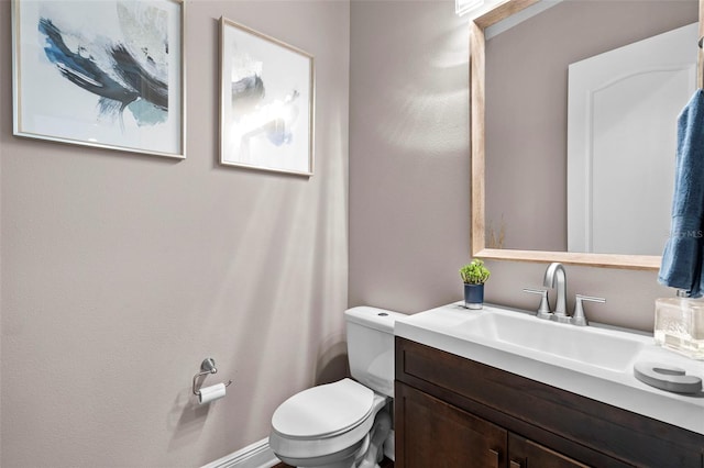 bathroom with toilet and vanity