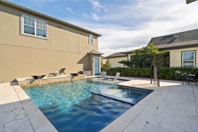 view of swimming pool featuring an in ground hot tub and a patio