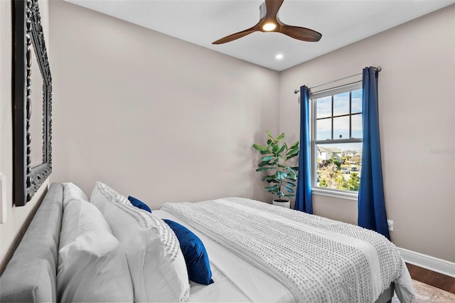 bedroom with ceiling fan and wood-type flooring