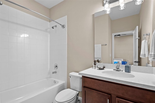 full bathroom featuring toilet, vanity, and tiled shower / bath