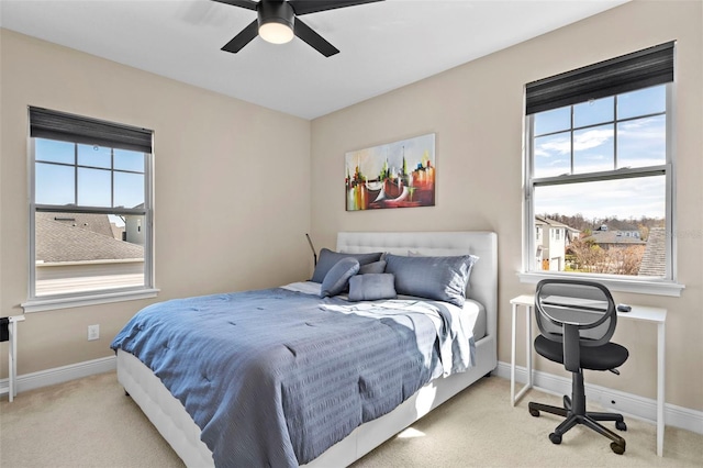 carpeted bedroom with multiple windows and ceiling fan