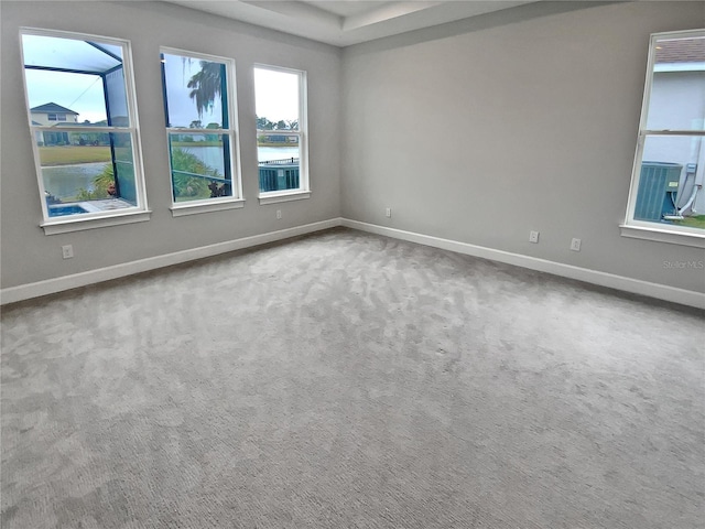 spare room featuring carpet flooring and a water view