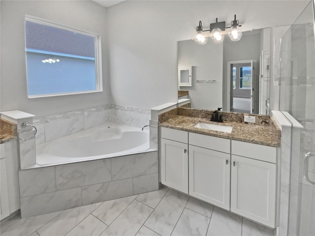 bathroom featuring vanity, separate shower and tub, and a wealth of natural light