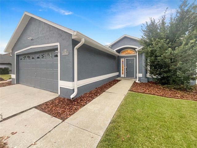 ranch-style house with a garage and a front lawn