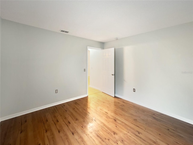 spare room with hardwood / wood-style flooring