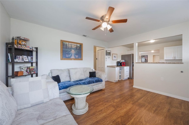 living room featuring wood-type flooring and ceiling fan