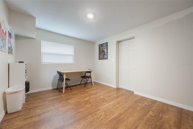 office with light wood-type flooring