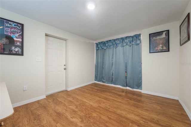 empty room featuring wood-type flooring