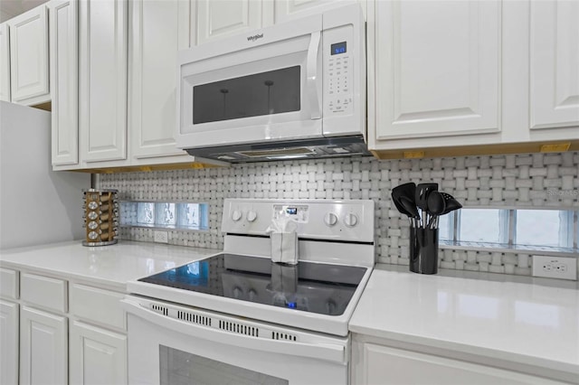 kitchen featuring white cabinetry and white appliances