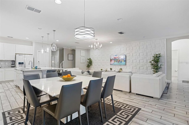 dining area featuring crown molding and a chandelier