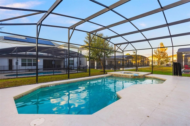 view of swimming pool with an in ground hot tub, a lanai, and a patio