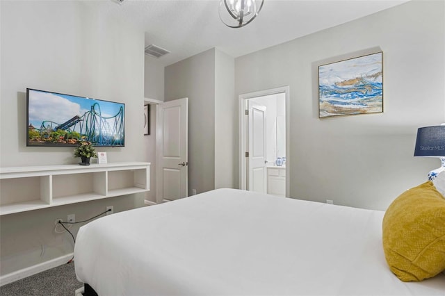 carpeted bedroom featuring ensuite bath