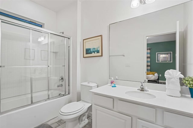 full bathroom featuring vanity, toilet, and combined bath / shower with glass door