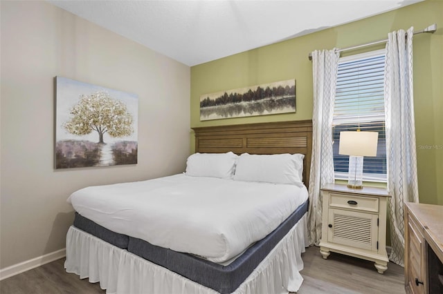 bedroom with hardwood / wood-style flooring