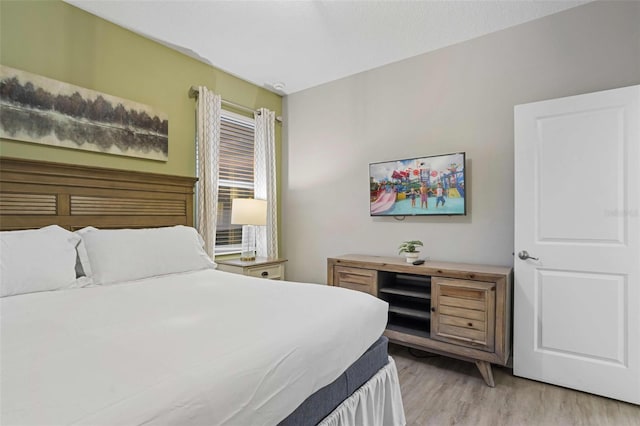 bedroom with light wood-type flooring