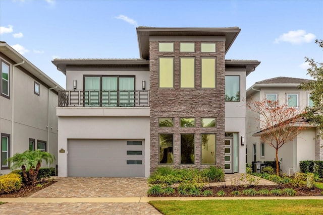 view of front of home featuring a garage and a balcony