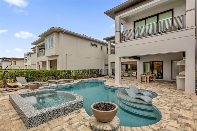 view of pool with an in ground hot tub and a patio