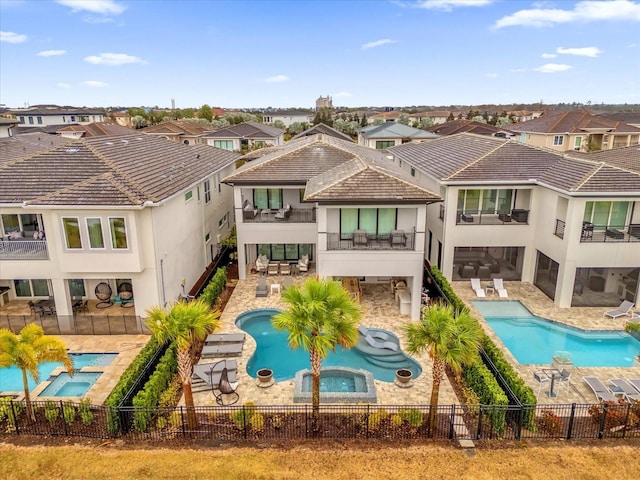 back of house featuring a pool with hot tub and a patio area