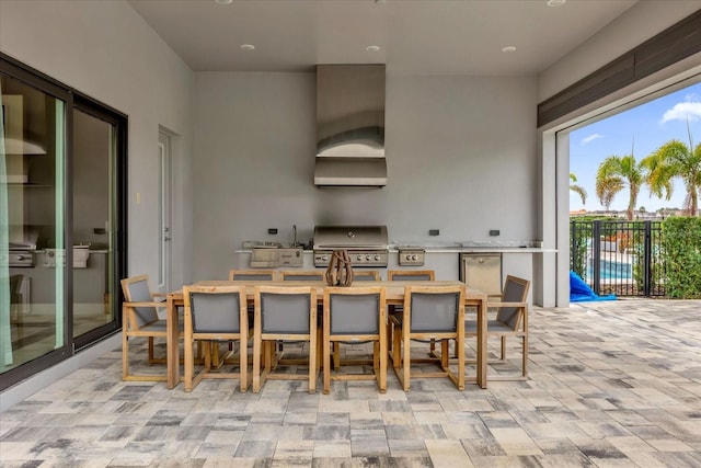 kitchen with refrigerator and wall chimney range hood