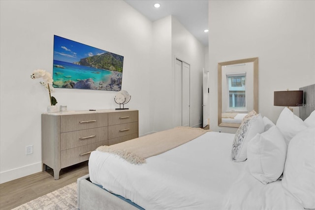 bedroom with a closet and light hardwood / wood-style flooring