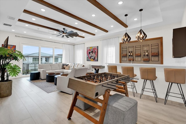 game room with ceiling fan, a wealth of natural light, and light wood-type flooring