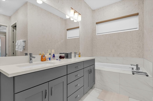 bathroom featuring vanity, tile patterned floors, and tiled bath