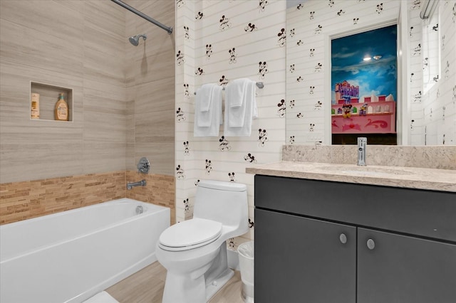 full bathroom featuring vanity, toilet, and  shower combination