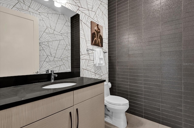 bathroom featuring vanity, toilet, and tile patterned flooring