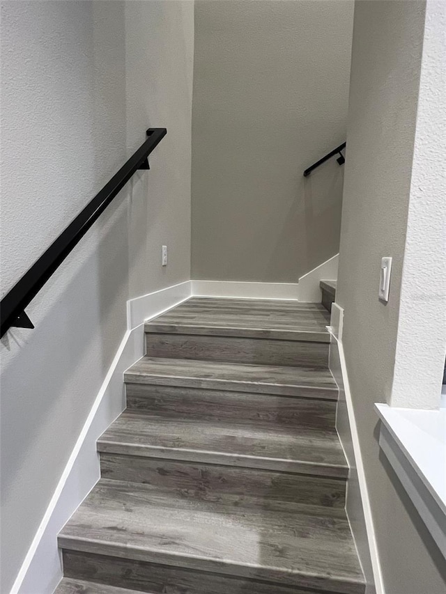 staircase featuring hardwood / wood-style floors