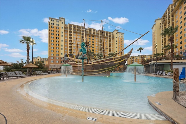 view of swimming pool with pool water feature