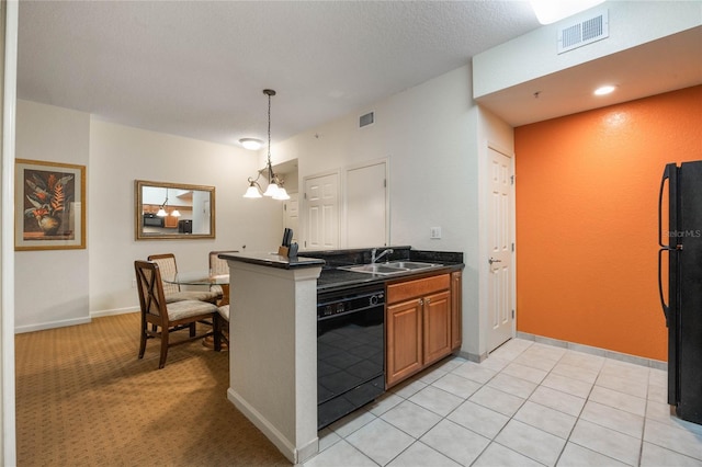 kitchen featuring hanging light fixtures, sink, light tile patterned floors, a notable chandelier, and black appliances