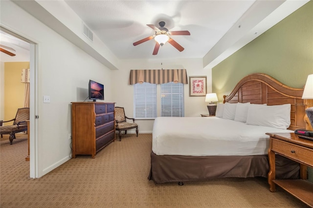 bedroom with ceiling fan and light carpet