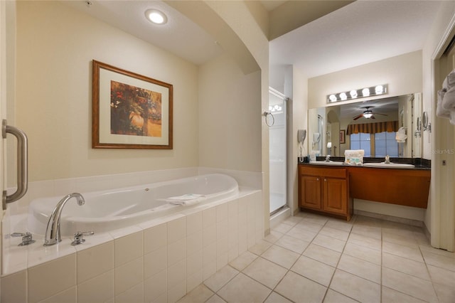 bathroom featuring independent shower and bath, tile patterned floors, and vanity