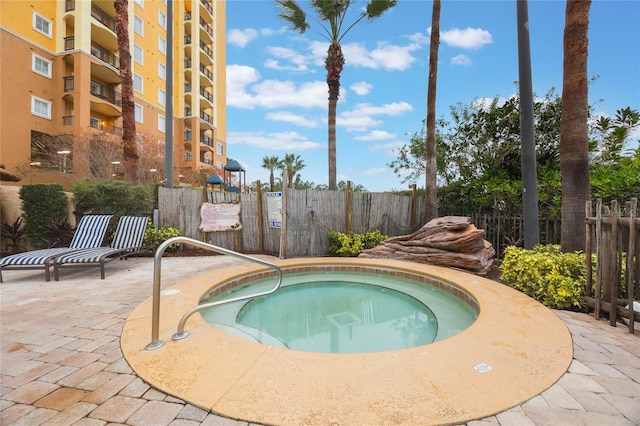 view of swimming pool with a hot tub and a patio