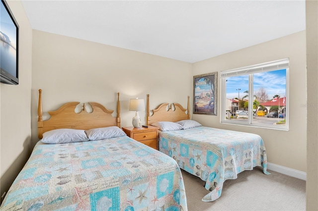 carpeted bedroom featuring baseboards