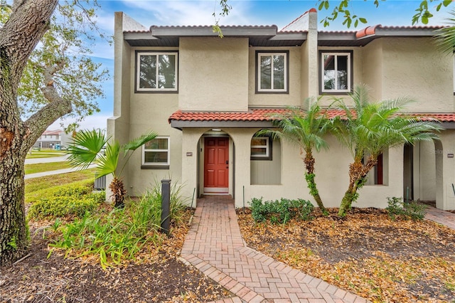 view of front of home with a tiled roof and stucco siding