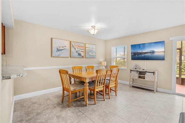 dining area with baseboards and light tile patterned floors
