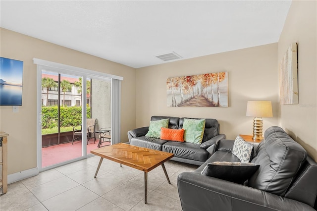 living area with visible vents, baseboards, and light tile patterned floors
