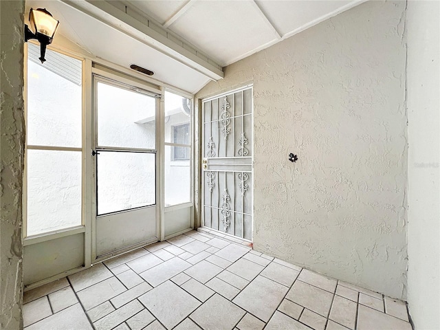 unfurnished sunroom with lofted ceiling