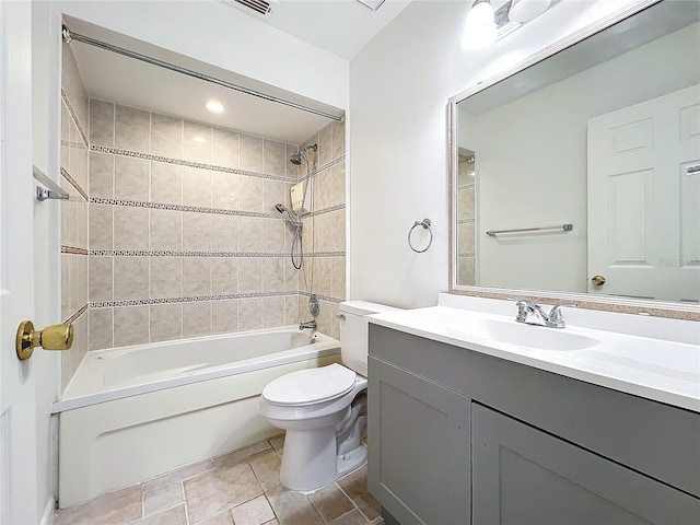 full bathroom featuring vanity, toilet, and tiled shower / bath combo